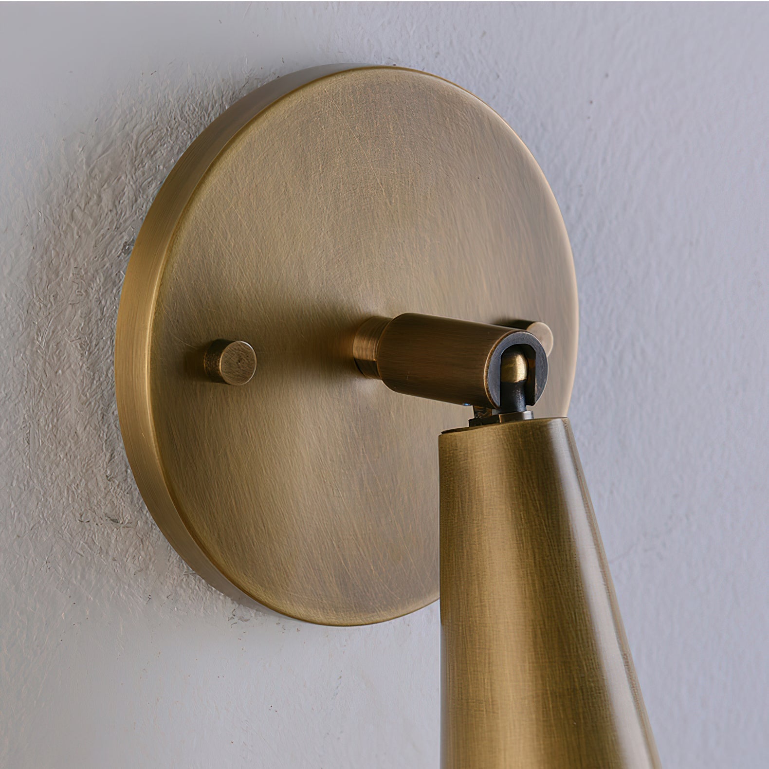 Donna Swivel Sconce installed in a bedroom setting.
