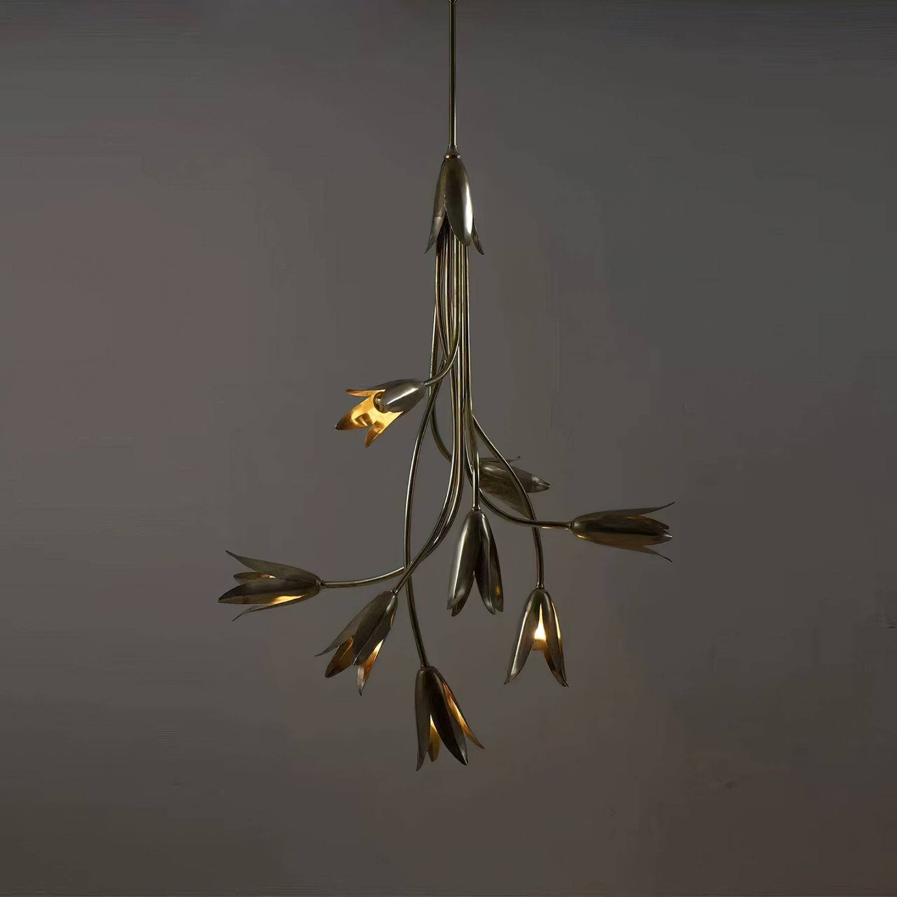 Close-up view of the brass tulip buds on the Evadne Chandelier.