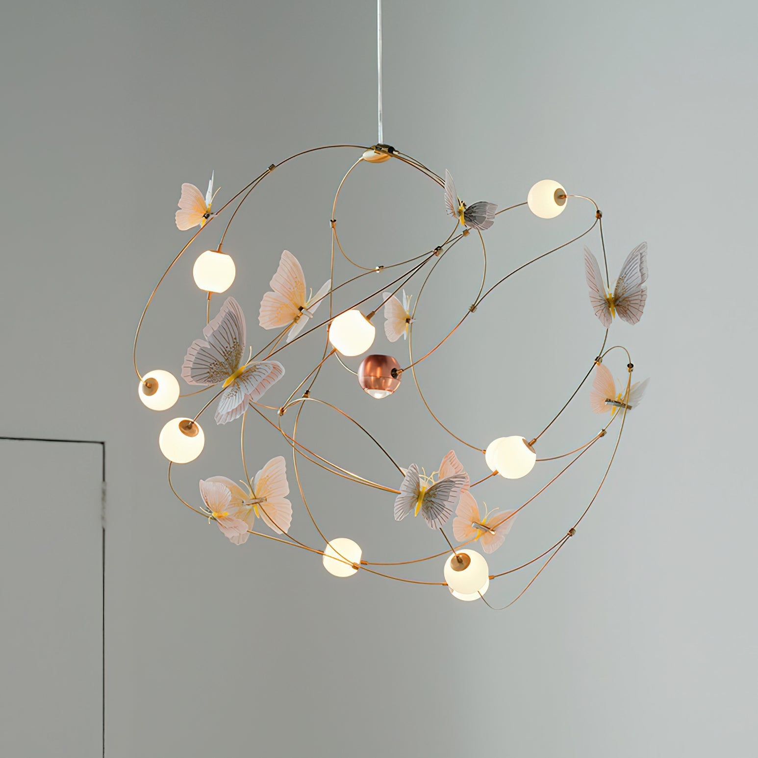 A lit view of the chandelier with yellow acrylic butterflies.