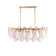 Flora Blush Ombre Linear Chandelier with pink glass leaves against a plain wall.