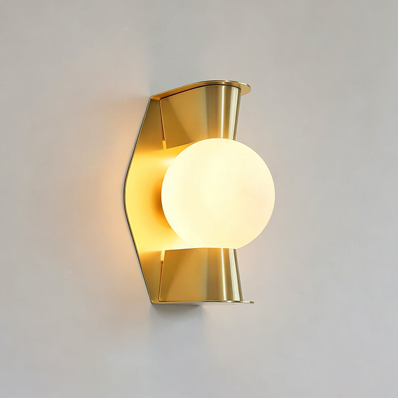 Detail shot of the metal construction and gold finish of the wall sconce.