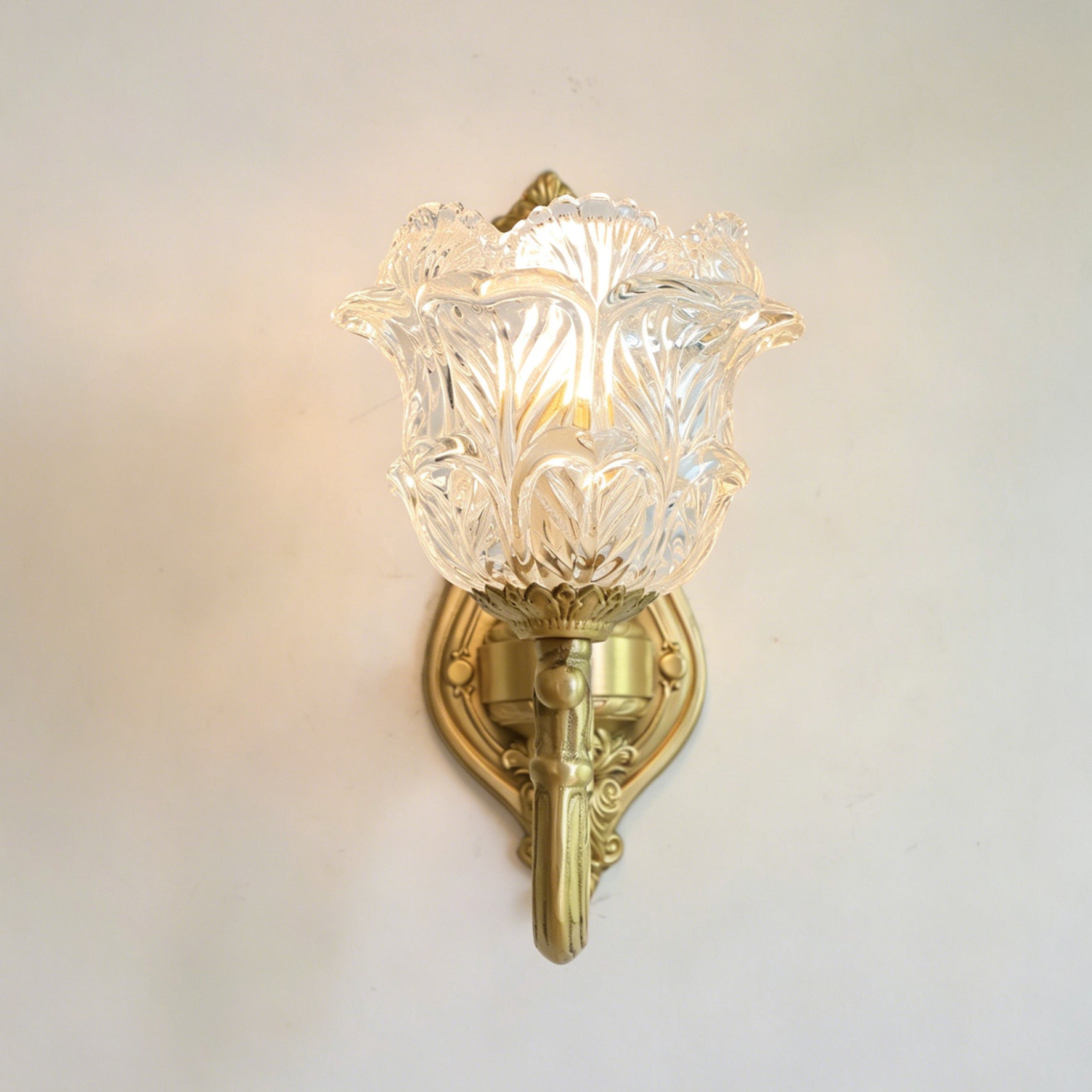 The Gideon sconce installed in a traditionally styled hallway next to a mirror.