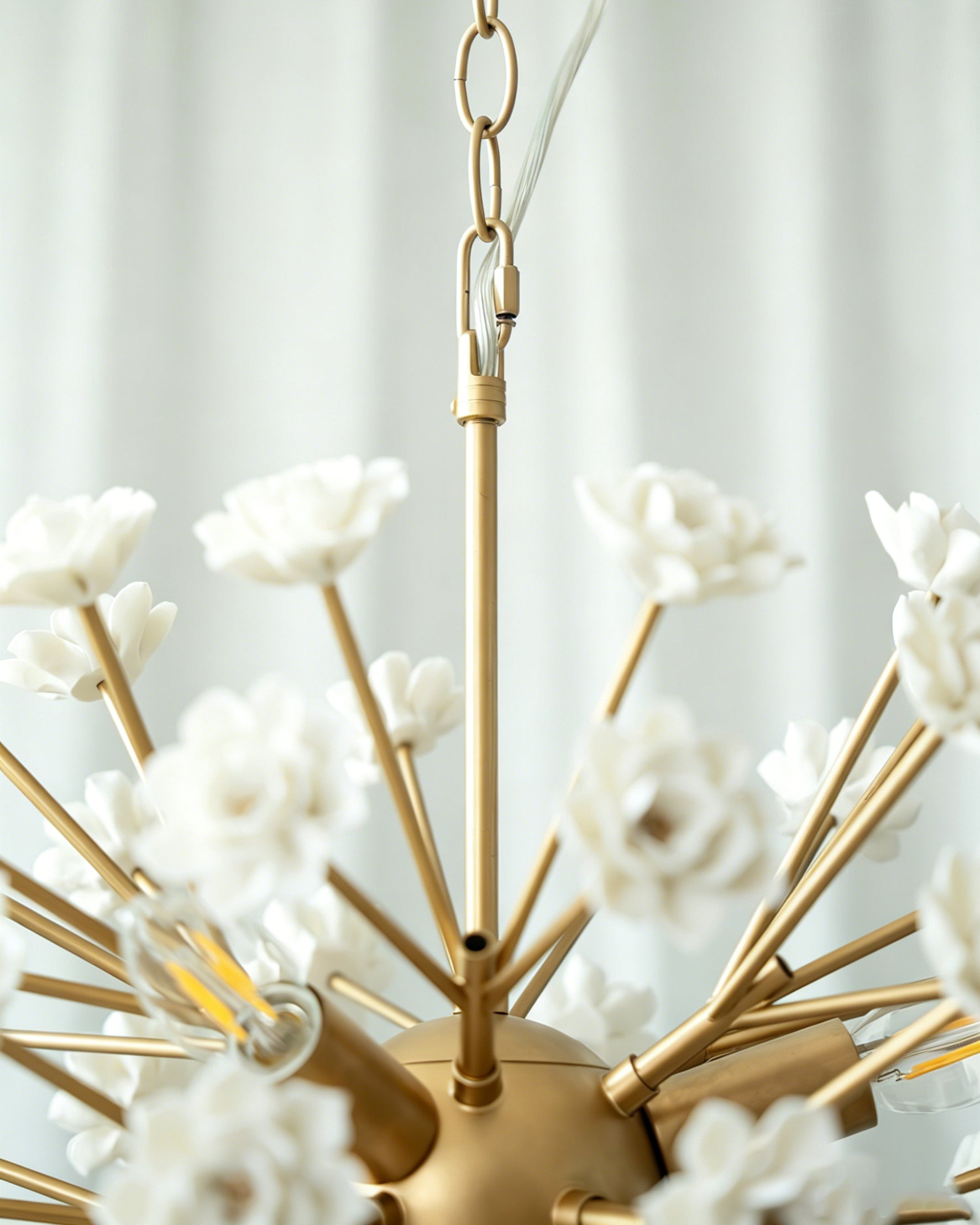 Detailed view of the gold metal frame and ceramic floral elements.