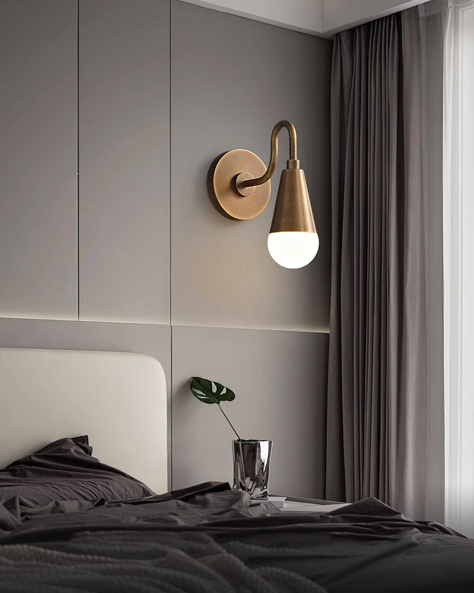 Lifestyle image of two Harlan Gooseneck Sconces flanking a bathroom mirror.