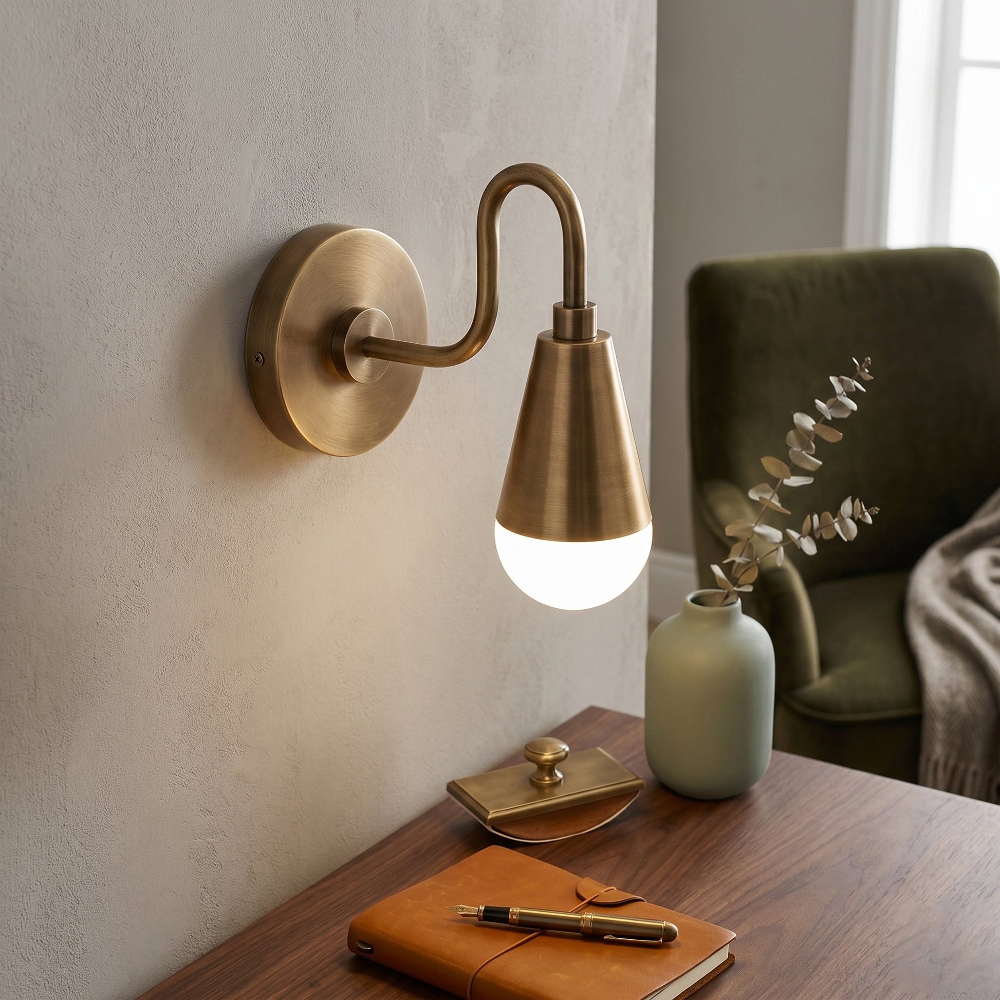 Close-up shot of the antique brass finish and gooseneck arm.