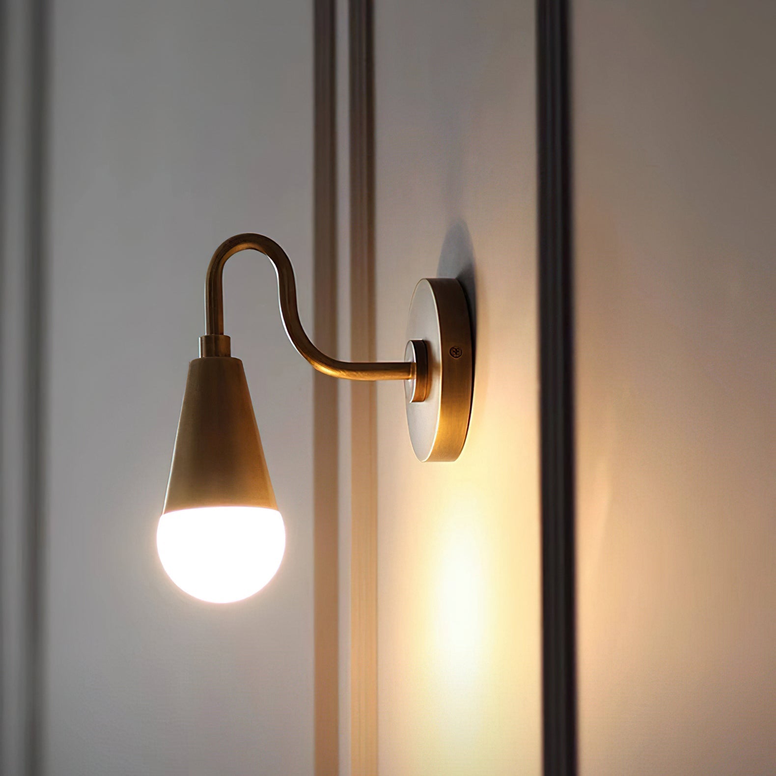 Harlan Gooseneck Sconce providing warm light in a cozy reading nook.