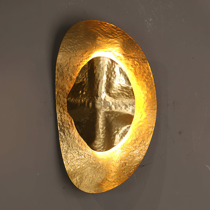 Product-only shot of the Helios Hammered Brass Sconce on a plain background.