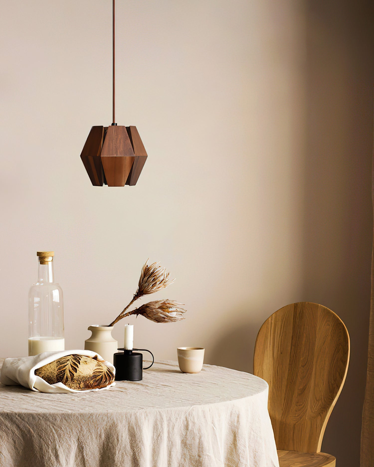 A modern kitchen island illuminated by the Kaden Wood Pendant Light.
