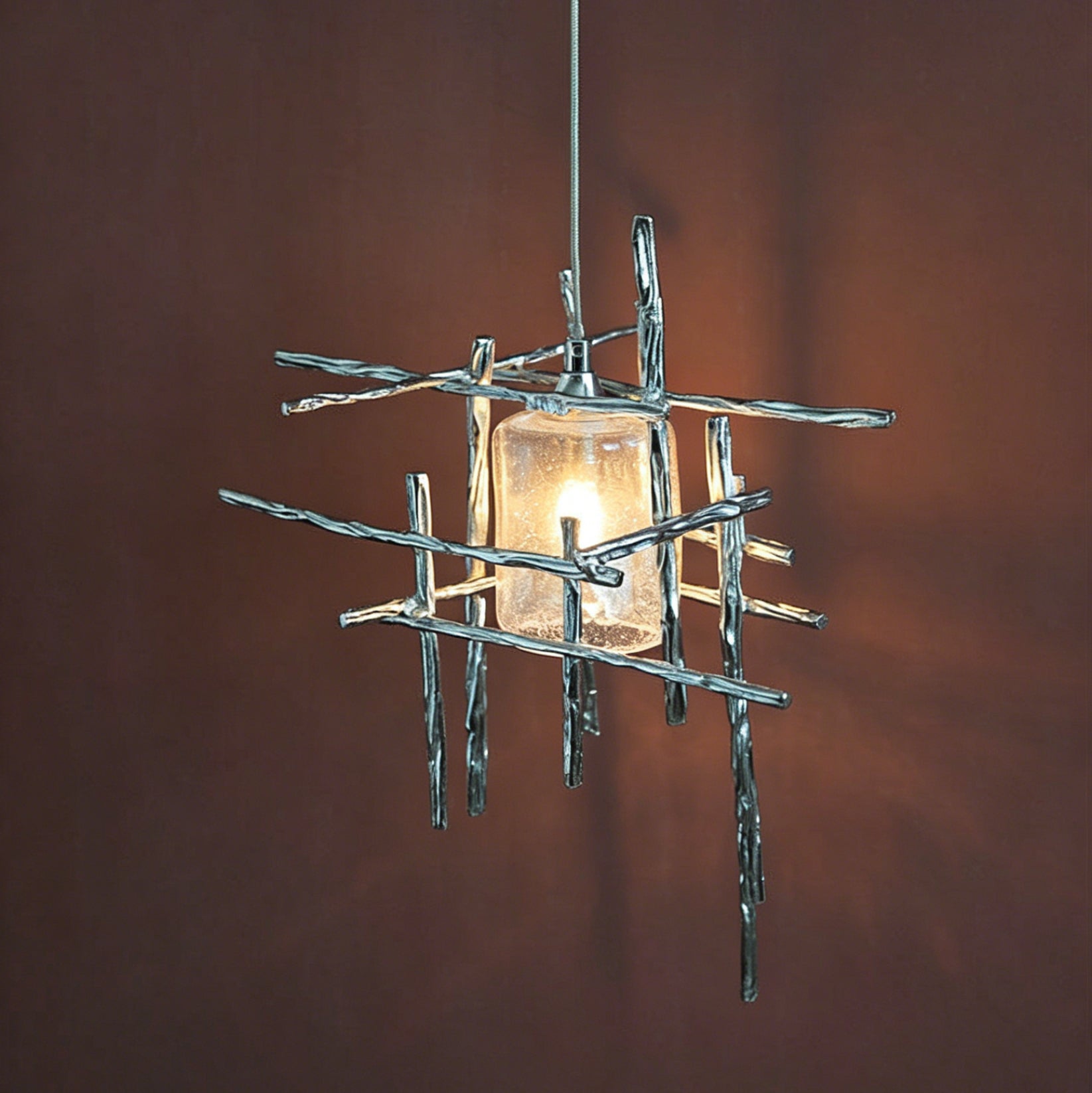 A Kova Glass Pendant Light hanging over a contemporary kitchen island.