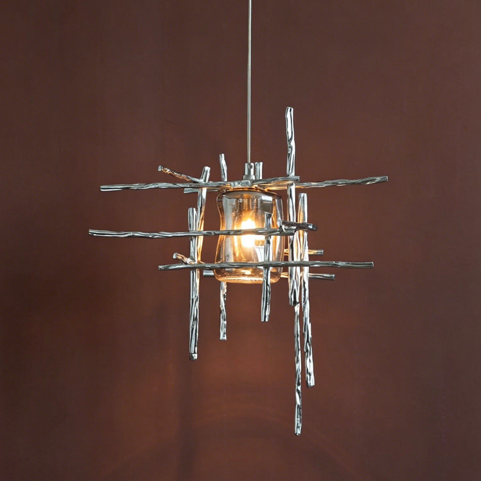 The Kova Pendant Light illuminated, casting a warm glow.