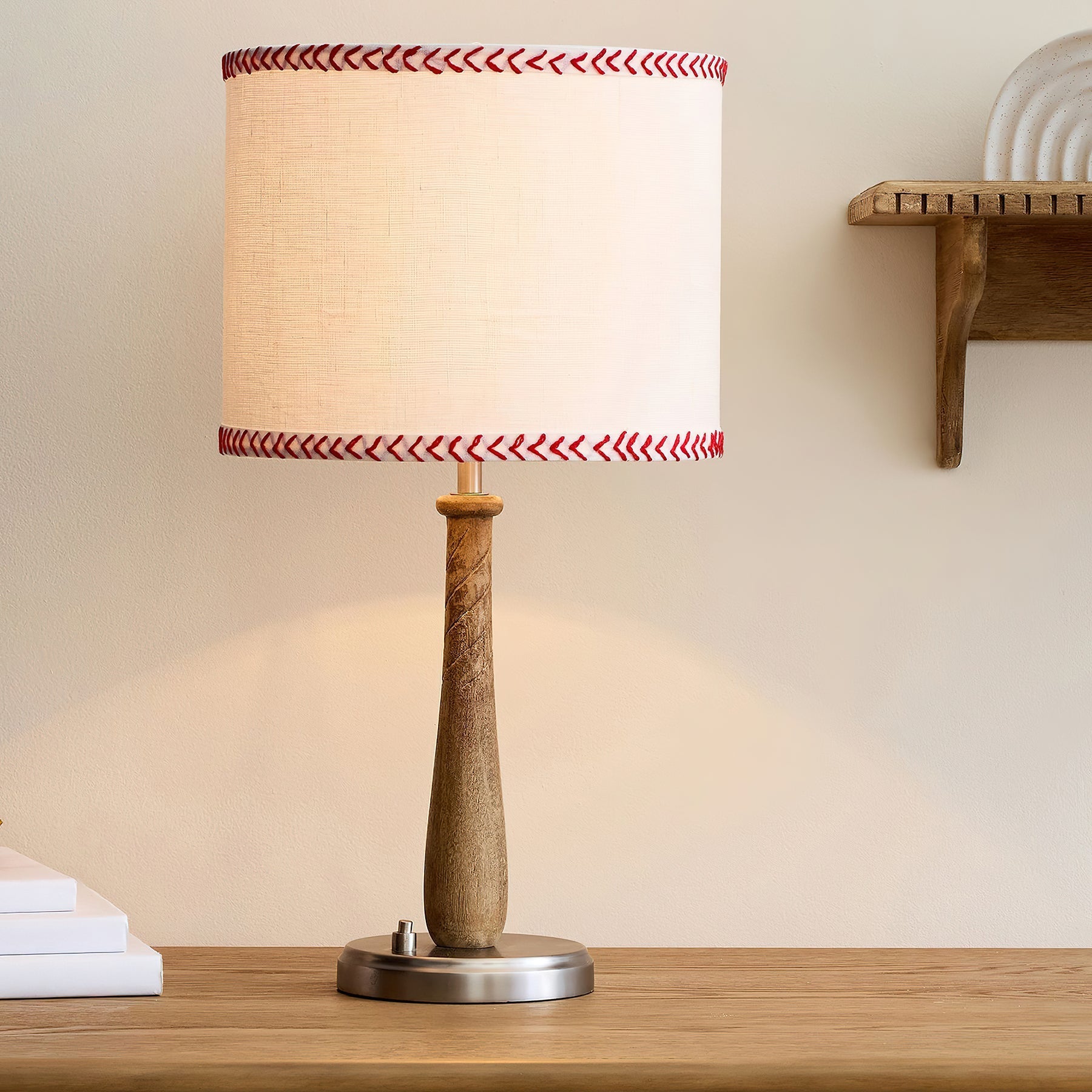 Close-up view of the Mitchell Table Lamp's walnut wood baseball bat body.