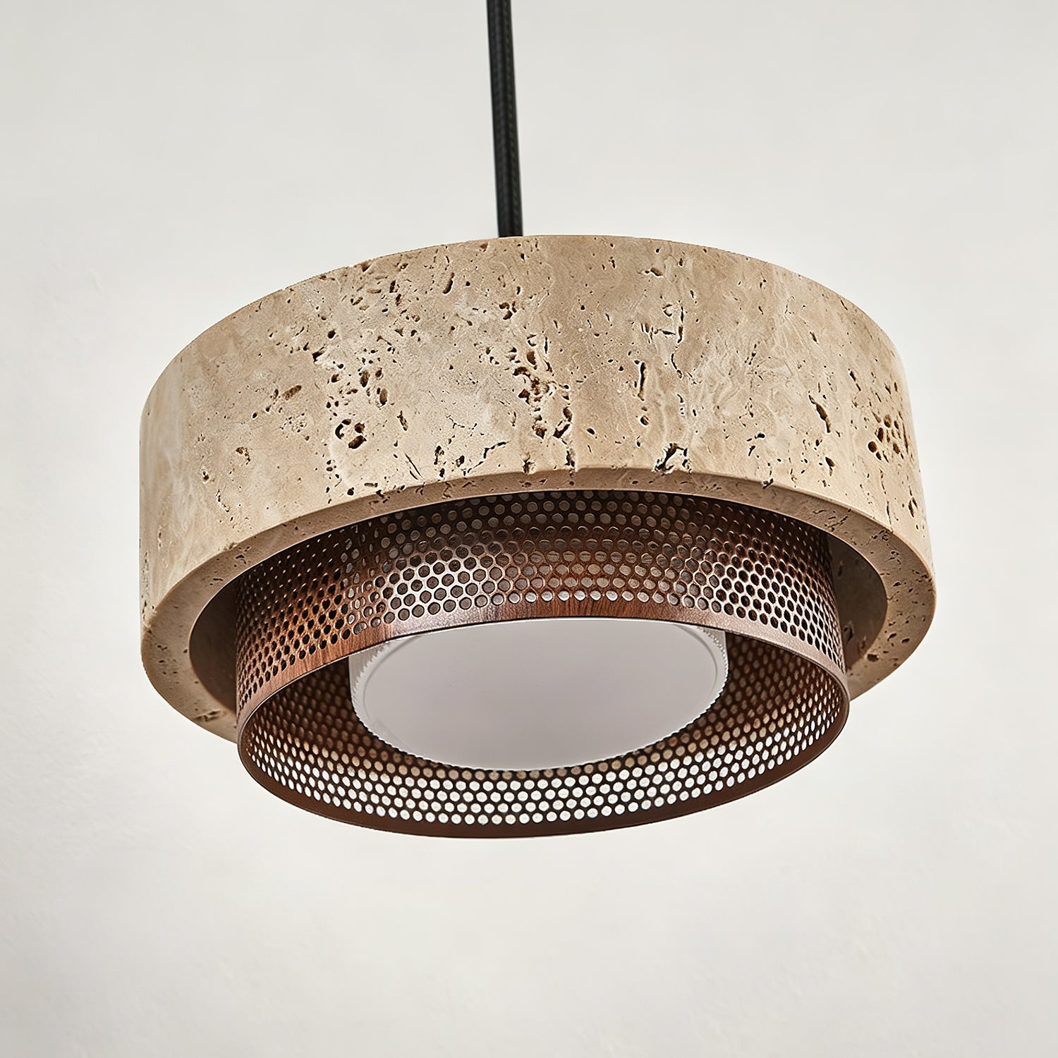 Angled view of the single Nolan Pendant Light showing its circular shape.