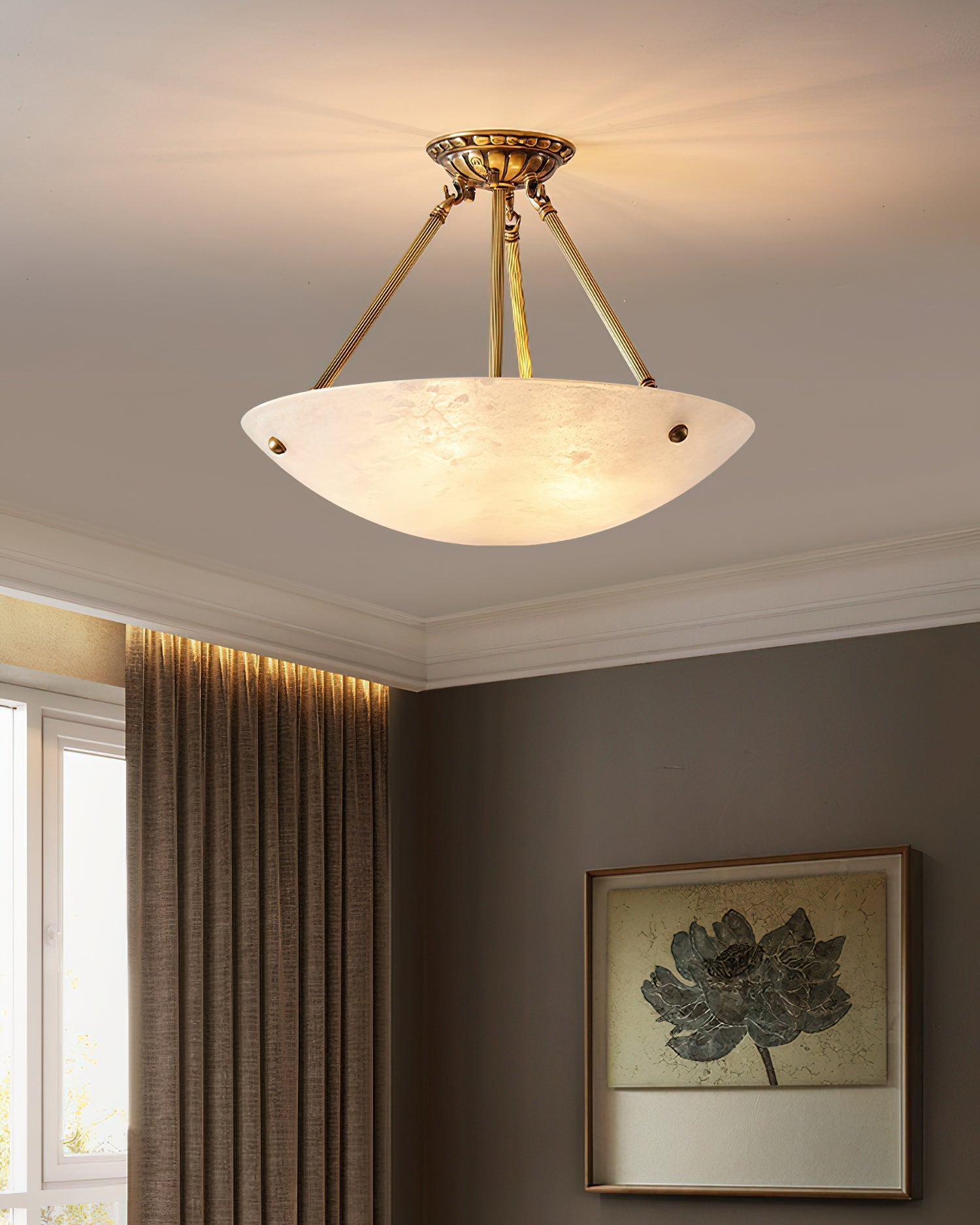 The pendant lamp shown in a primary bedroom above a bed.