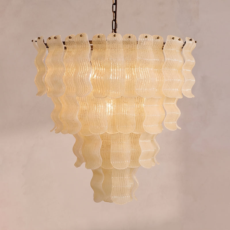 Close-up view of the textured, hand-poured glass ribbons of the Pollensa chandelier.