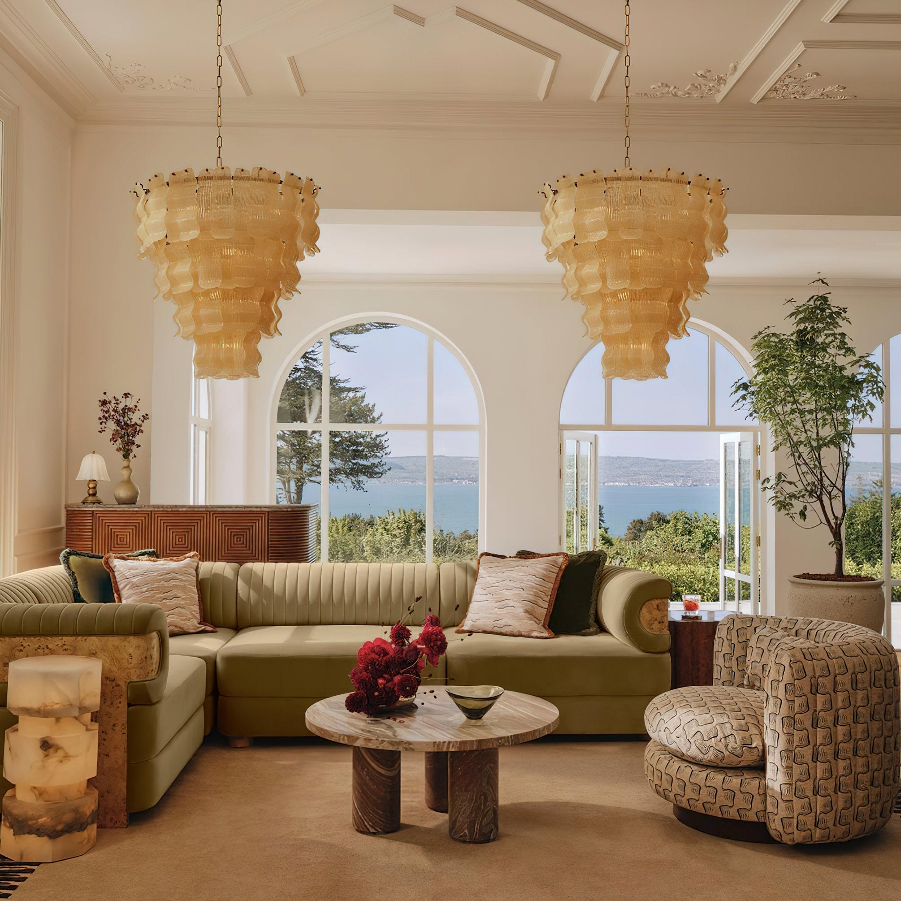 The multi-tiered Pollensa chandelier illuminated, showcasing its cascading design.