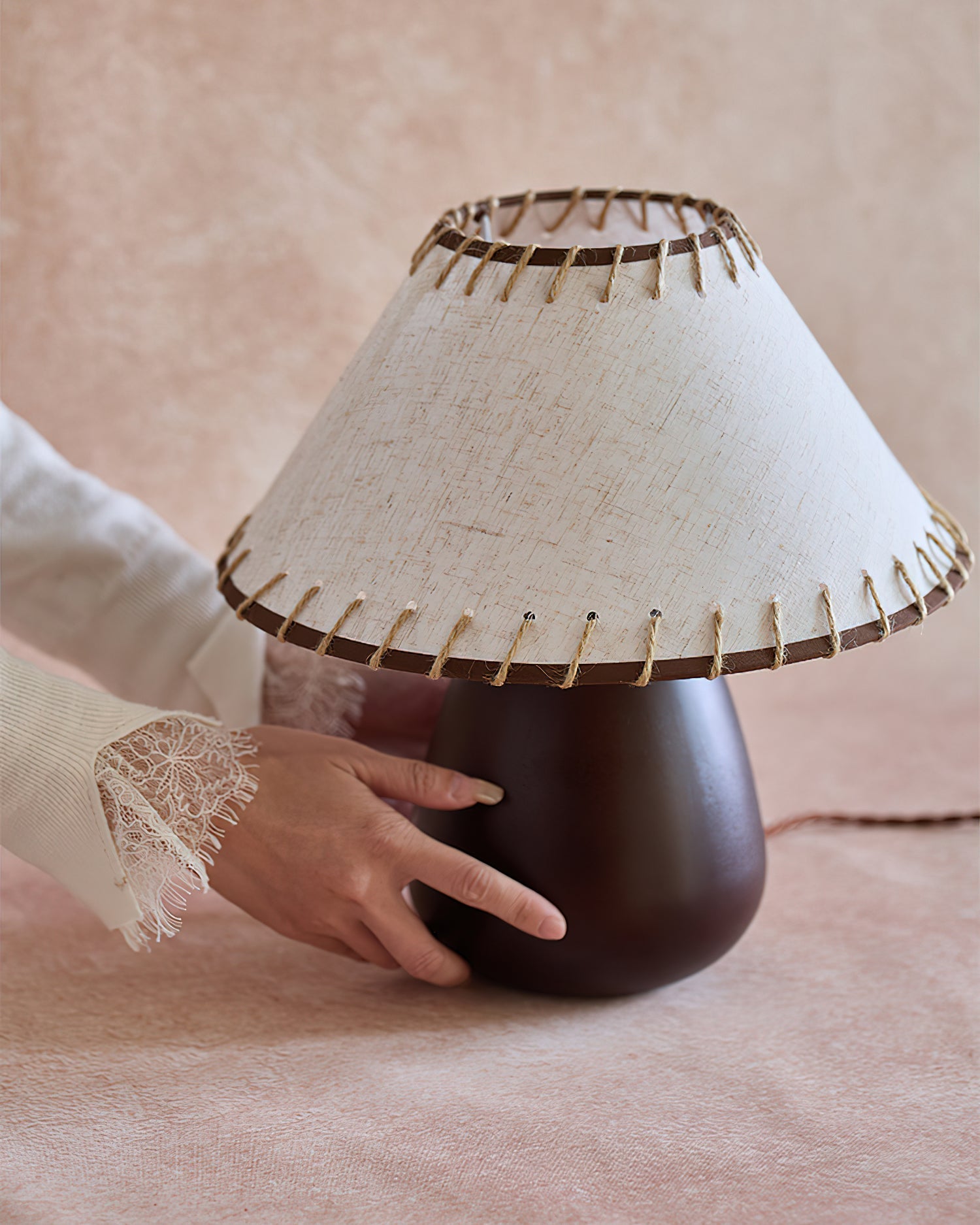 The smooth, rounded dark walnut wood base of the Douglas Table Lamp.