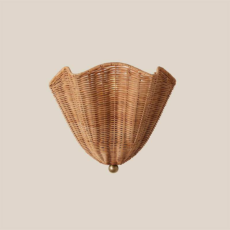 The sconce unlit, showcasing the natural color and texture of the rattan.