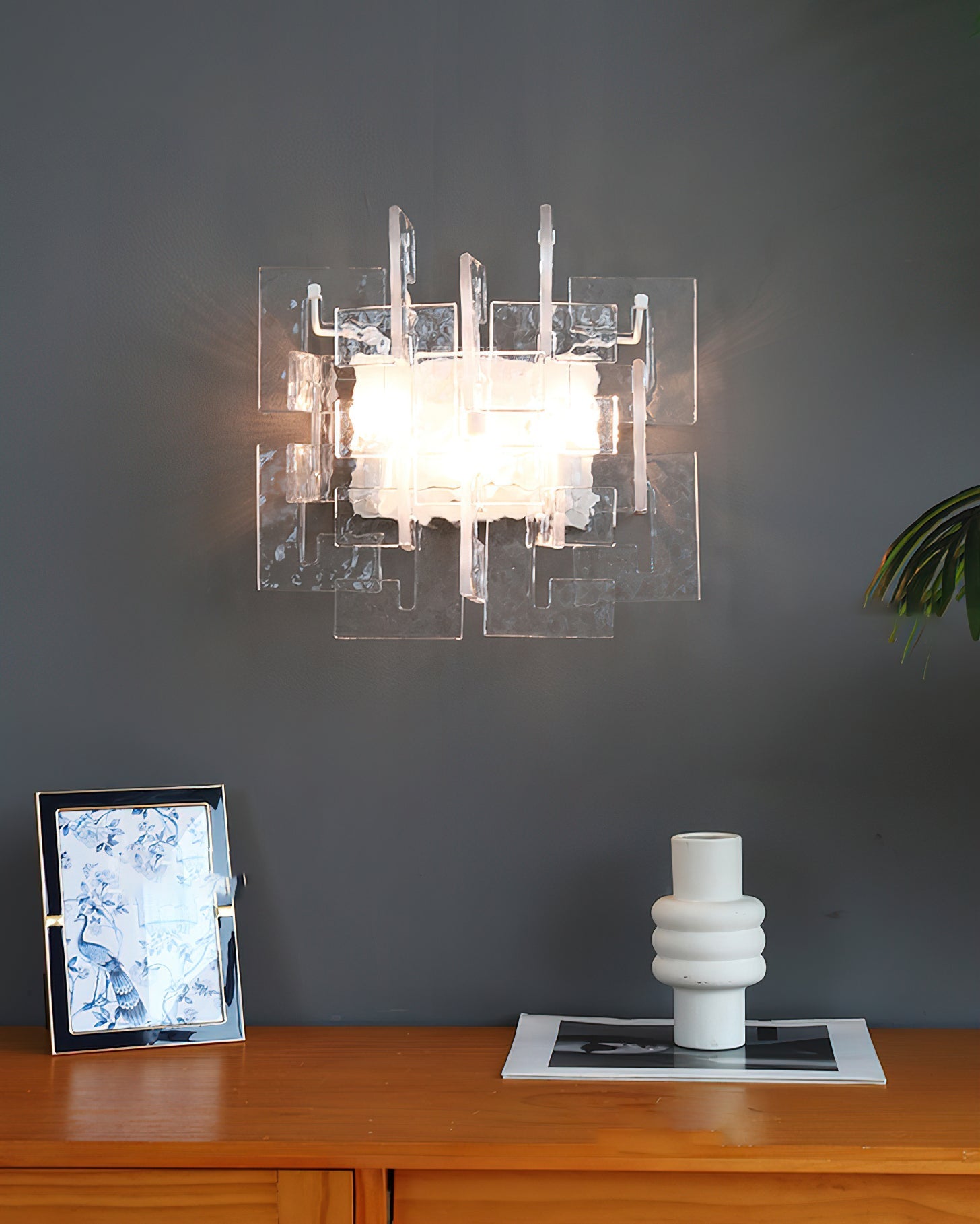 Angled view showcasing the geometric design of the Stagger Cast Glass Sconce.