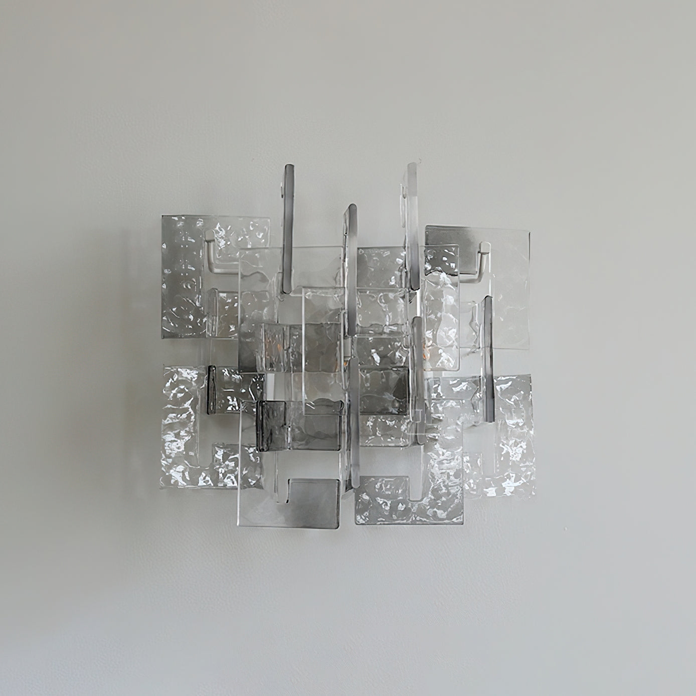The sconce unlit, highlighting the aqua tint of the glass.