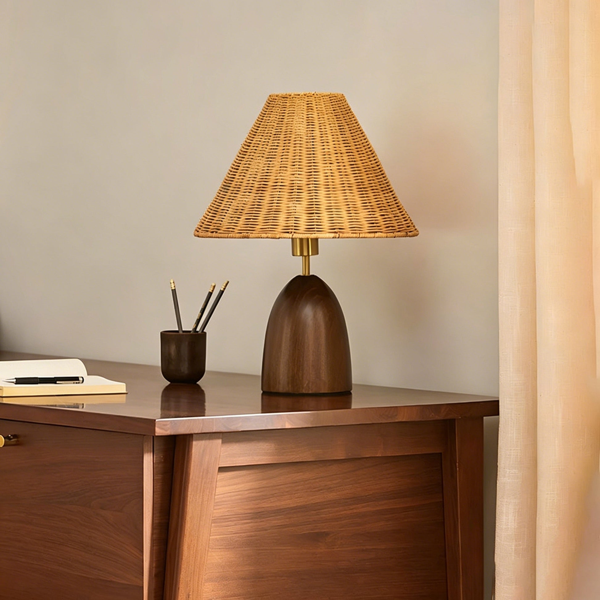 The Suri Rattan Table Lamp shown on a side table in a living room setting.