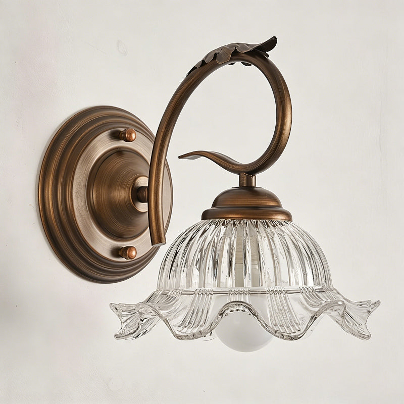The Sutton Wall Sconce turned on, casting a warm and inviting glow.