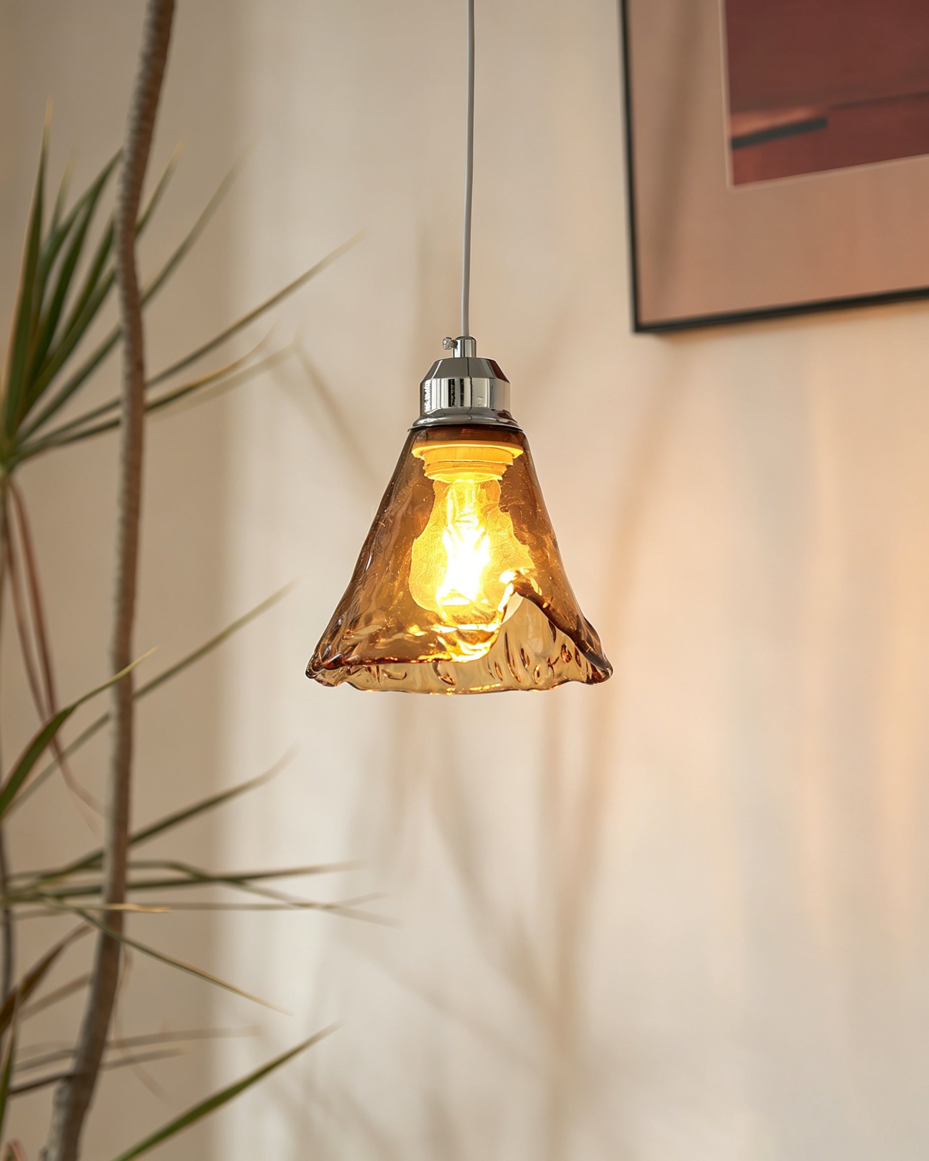 The three-head Tiro Glass Pendant Light installed over a kitchen island.
