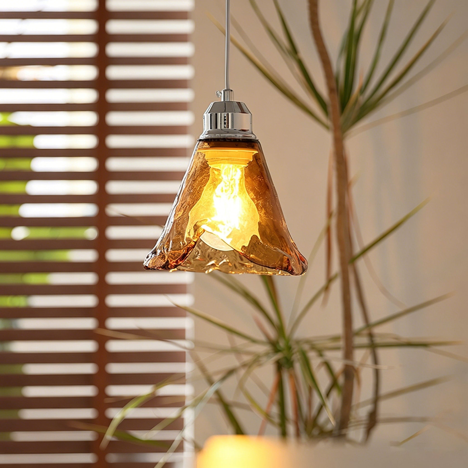 Three-head Tiro Glass Pendant Light hanging above a modern dining table.