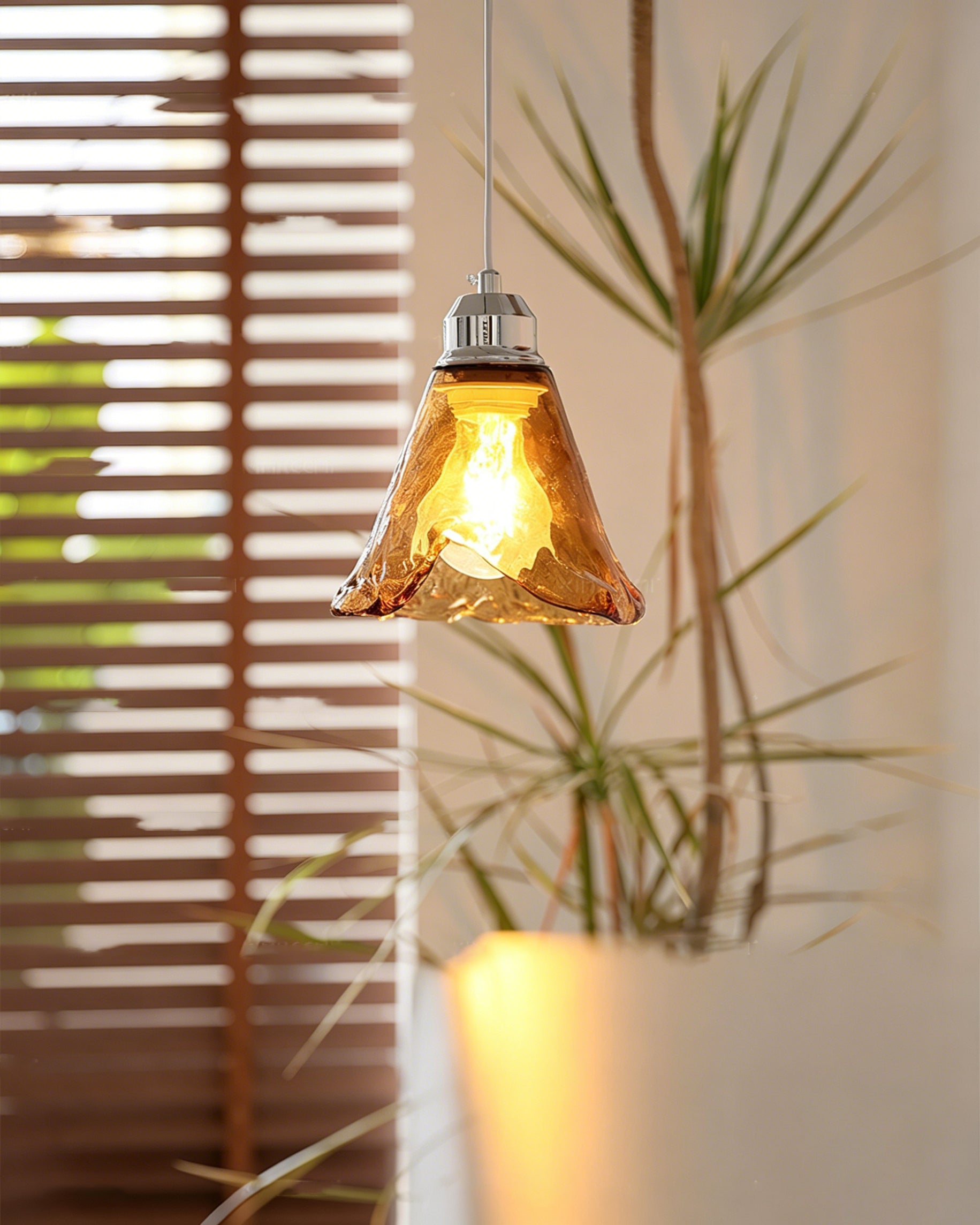 Detail shot of the chrome metalwork and ceiling canopy of the Tiro Pendant Light.