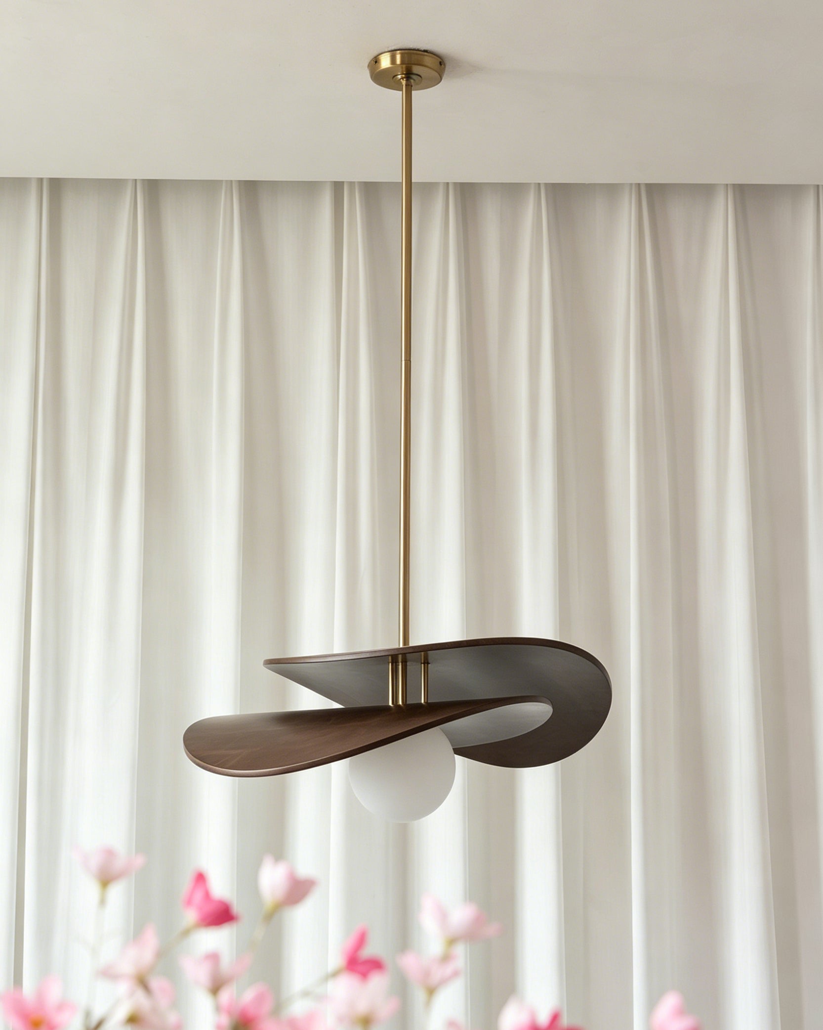 Lifestyle image of the Zane pendant light in a mid-century modern living room.