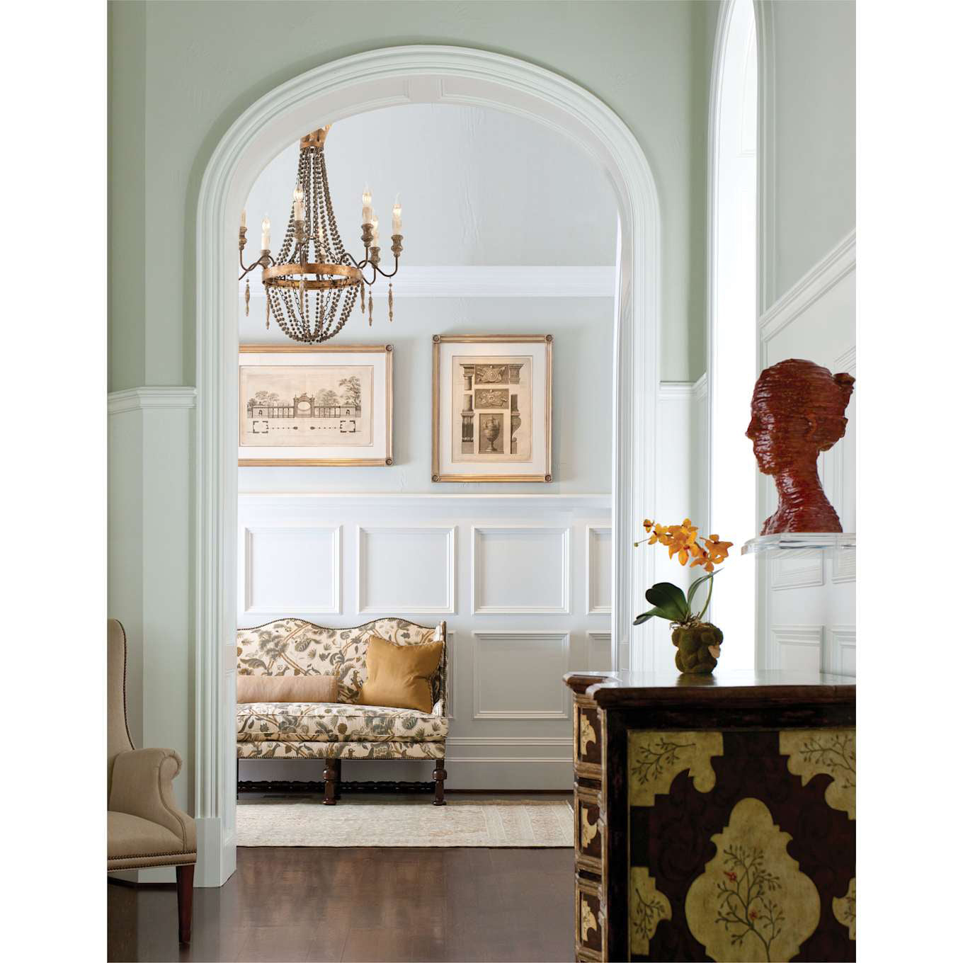 Lifestyle image featuring the Delacroix Chandelier over a wooden dining table.
