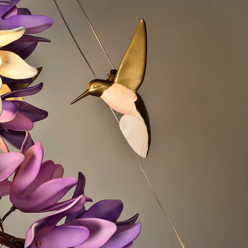 The Delphinium Purple Chandelier against a light wall.