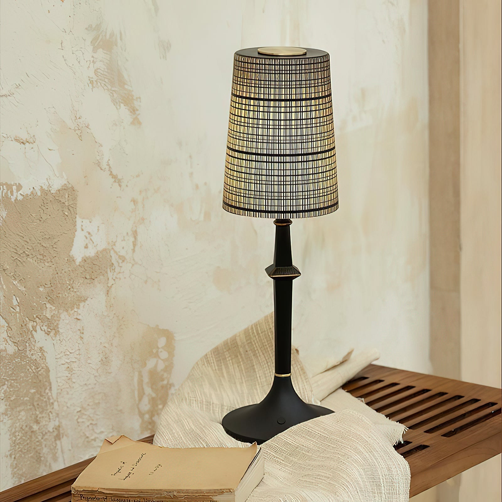 The Devon Black Table Lamp illuminated, casting a warm glow.