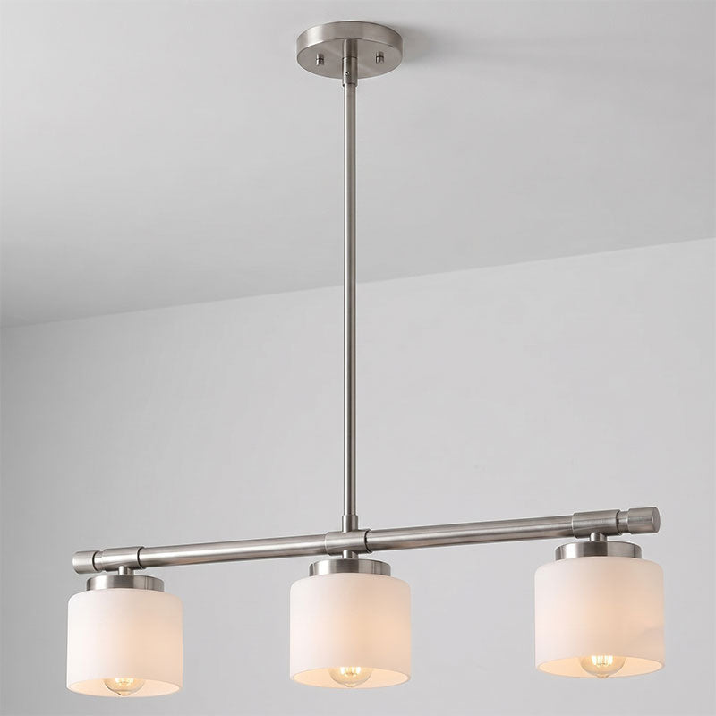 The Devon pendant in nickel finish over a rectangular dining table.