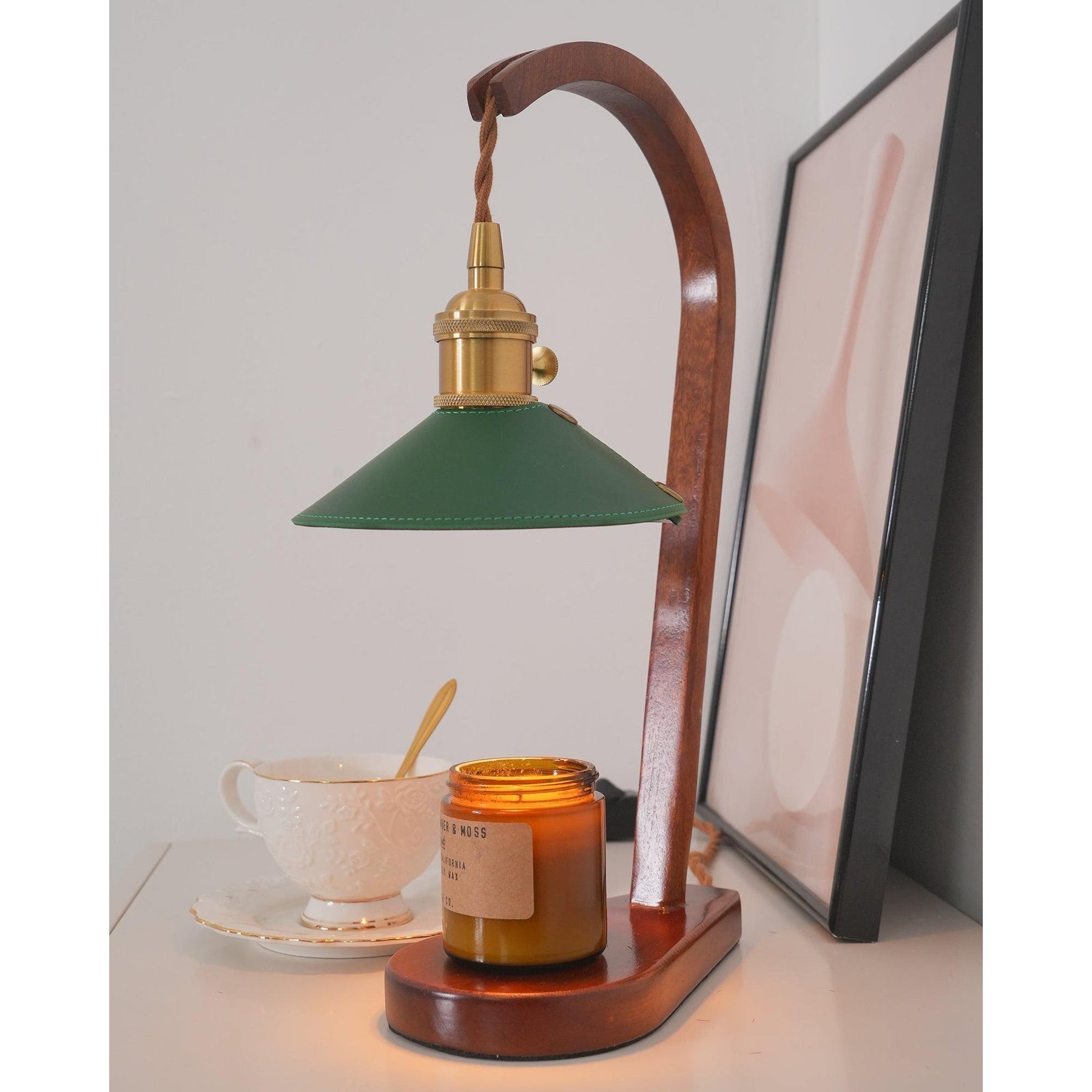 The lamp shown with a candle jar underneath to illustrate its function.