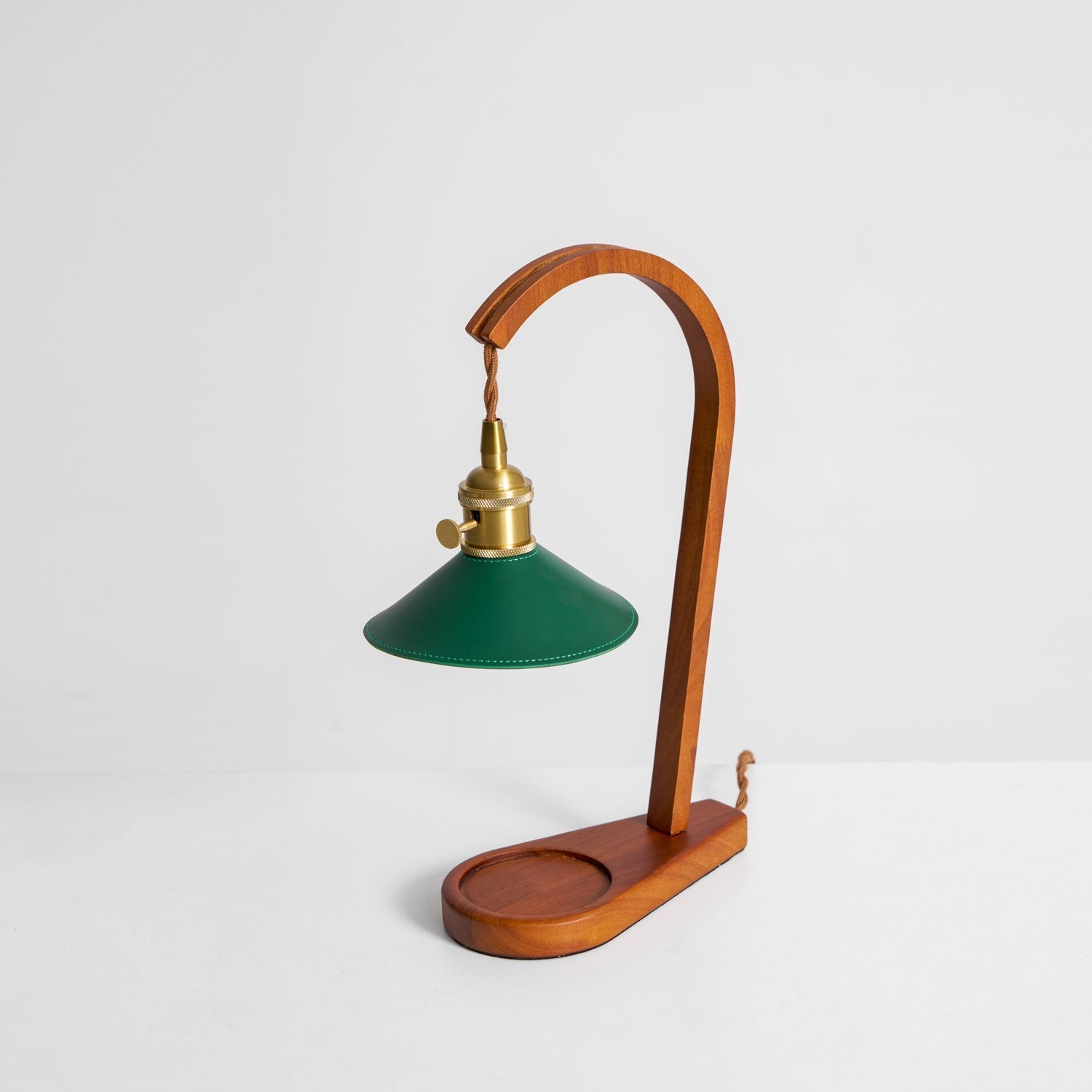Detail of the brass accent connecting the wood arm and the lamp head.