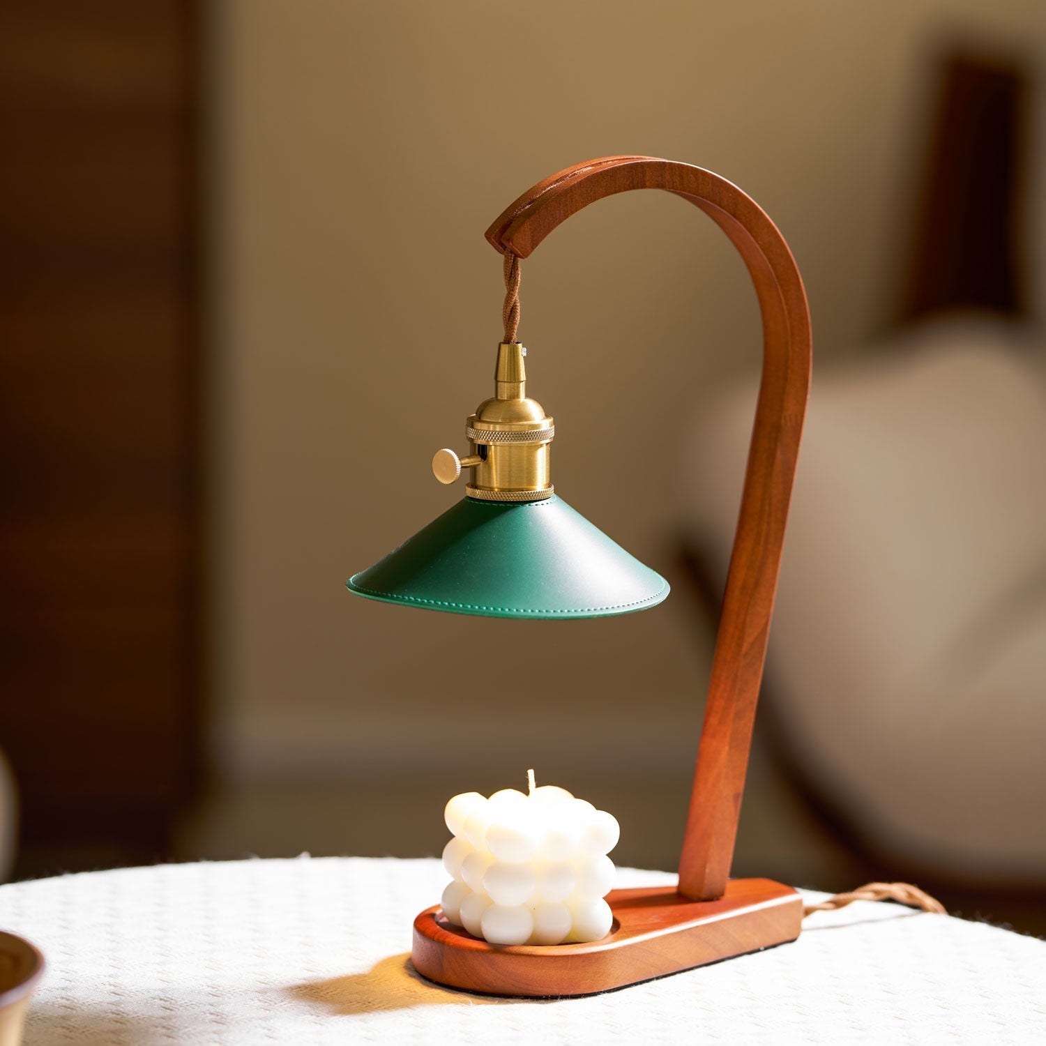 Side view of the Diosa Candle Warmer Lamp, showcasing its curved wooden frame.