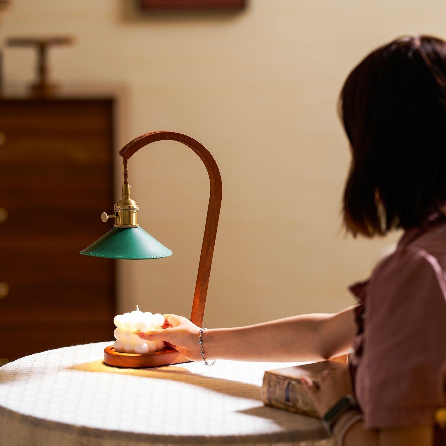 Diosa Candle Warmer Lamp styled on a side table in a living room.