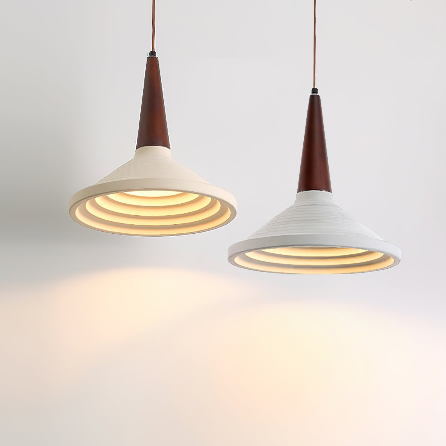 The Doherty Pendant Light shown against a dark, textured wall.