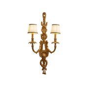 Dominique Brass Wall Lamp with a white fabric shade.