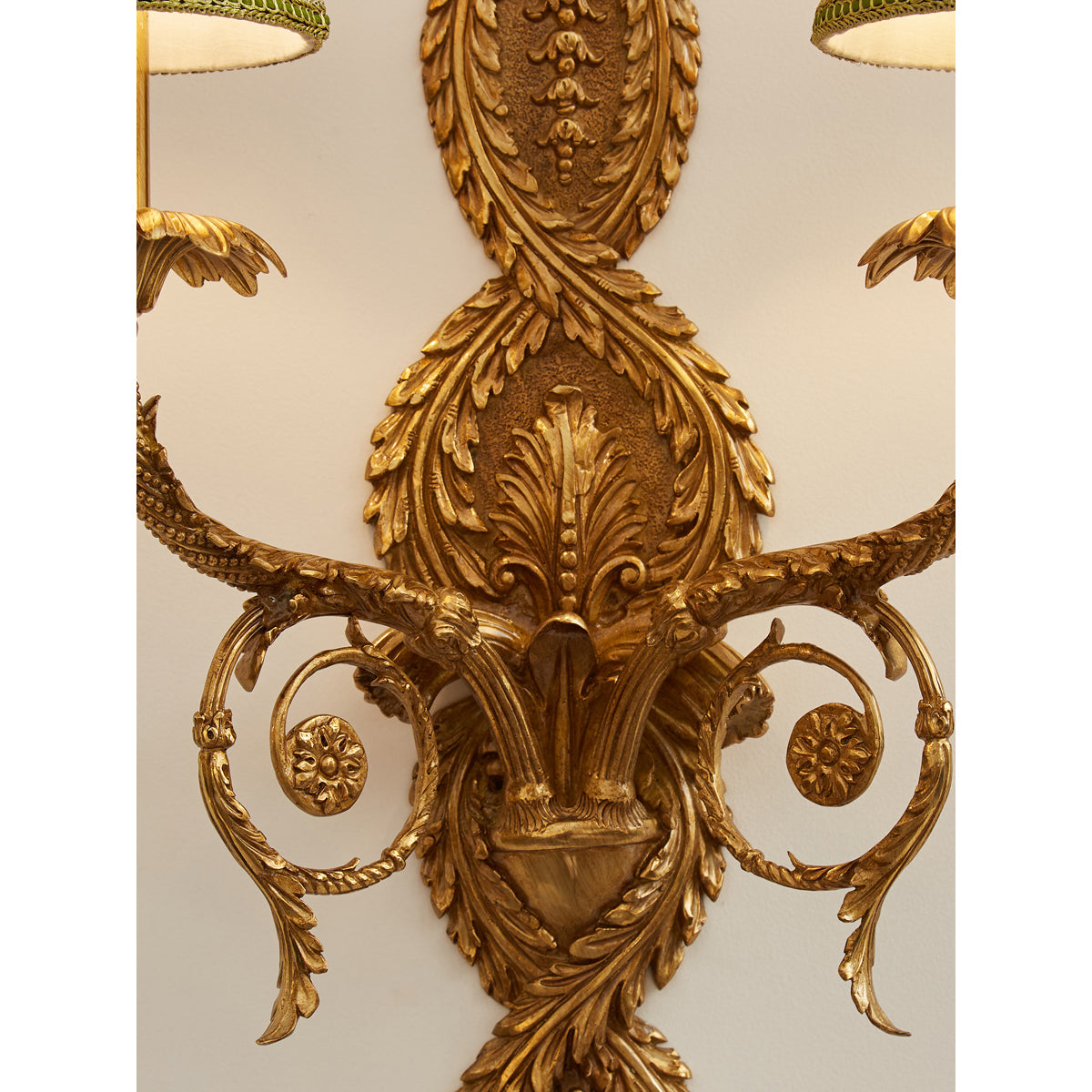 Detail of the connection between the brass arm and the lampshade.