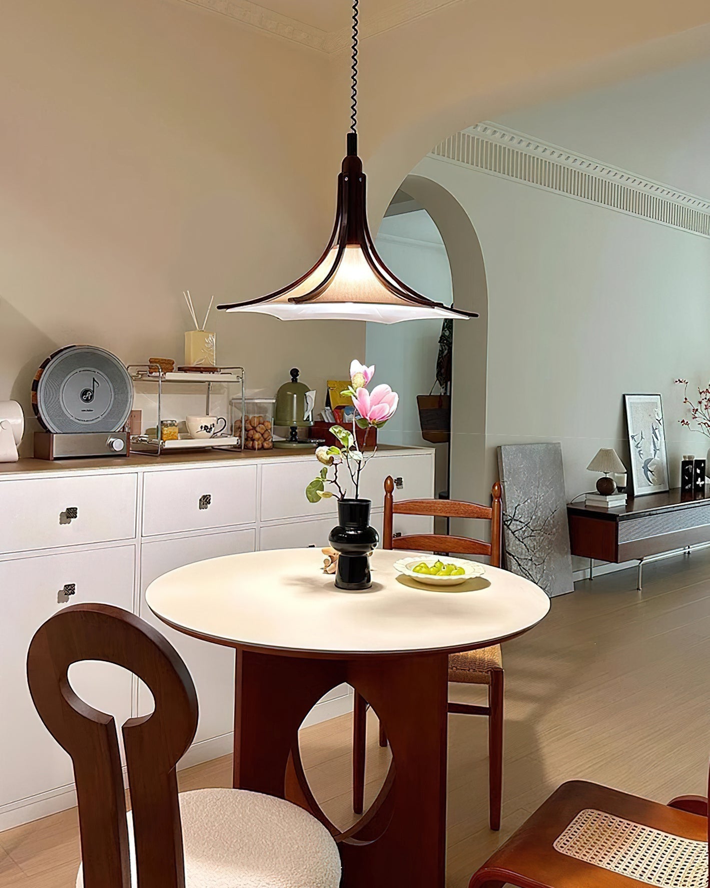 The pendant light in a bedroom setting, providing ambient light.