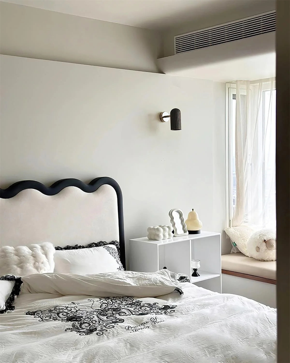 Donovan Wall Lamp installed as a bedside reading light in a modern bedroom.