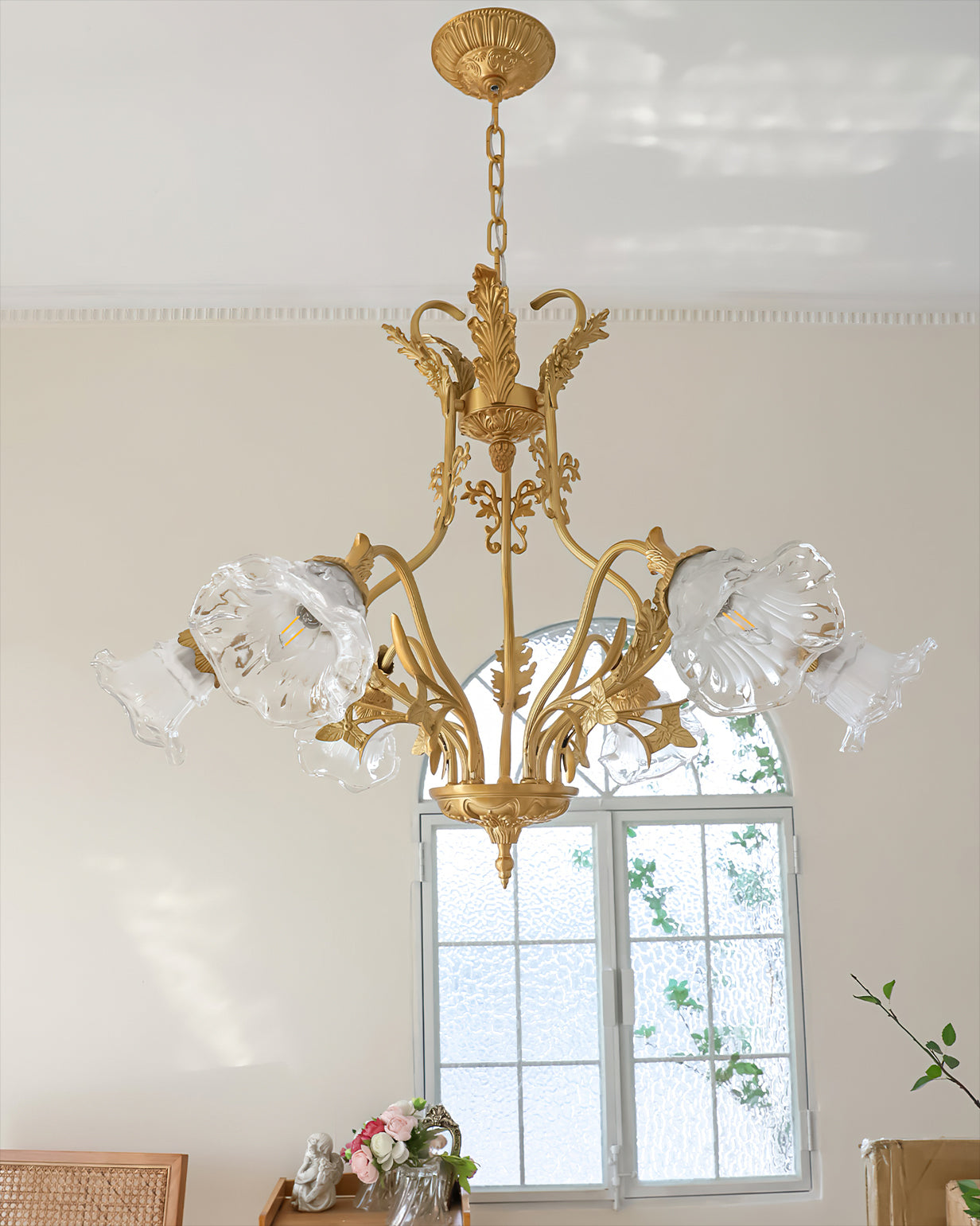 The chandelier illuminated, casting a warm glow in a living space.