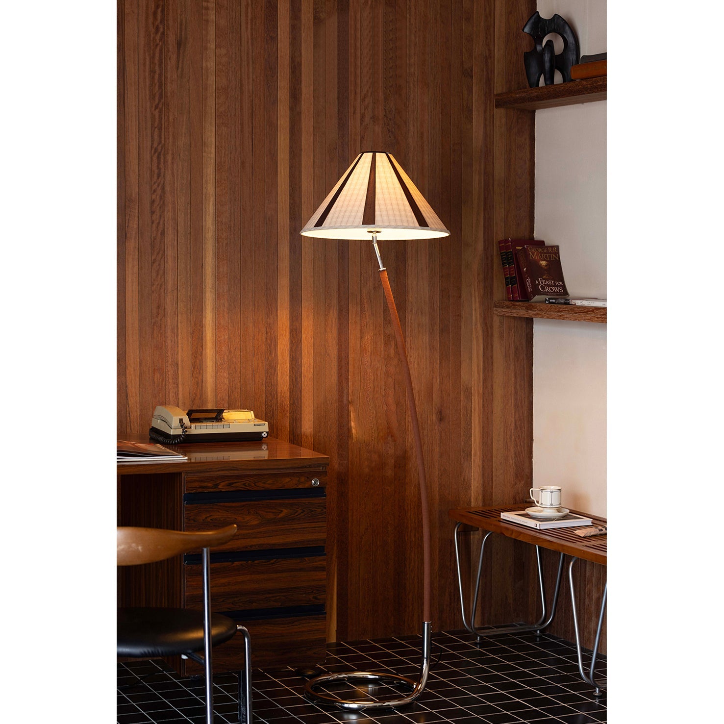The rich brown leather detailing wrapped around the lamp stem.