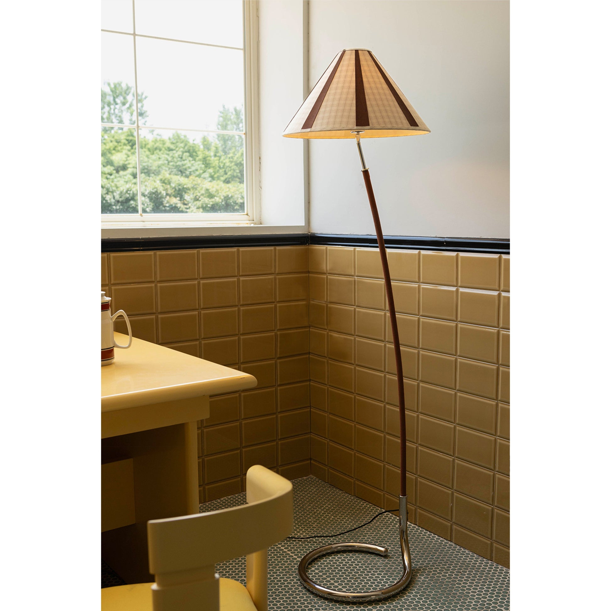 The Dornstab Floor Lamp adding ambiance to a minimalist office space.