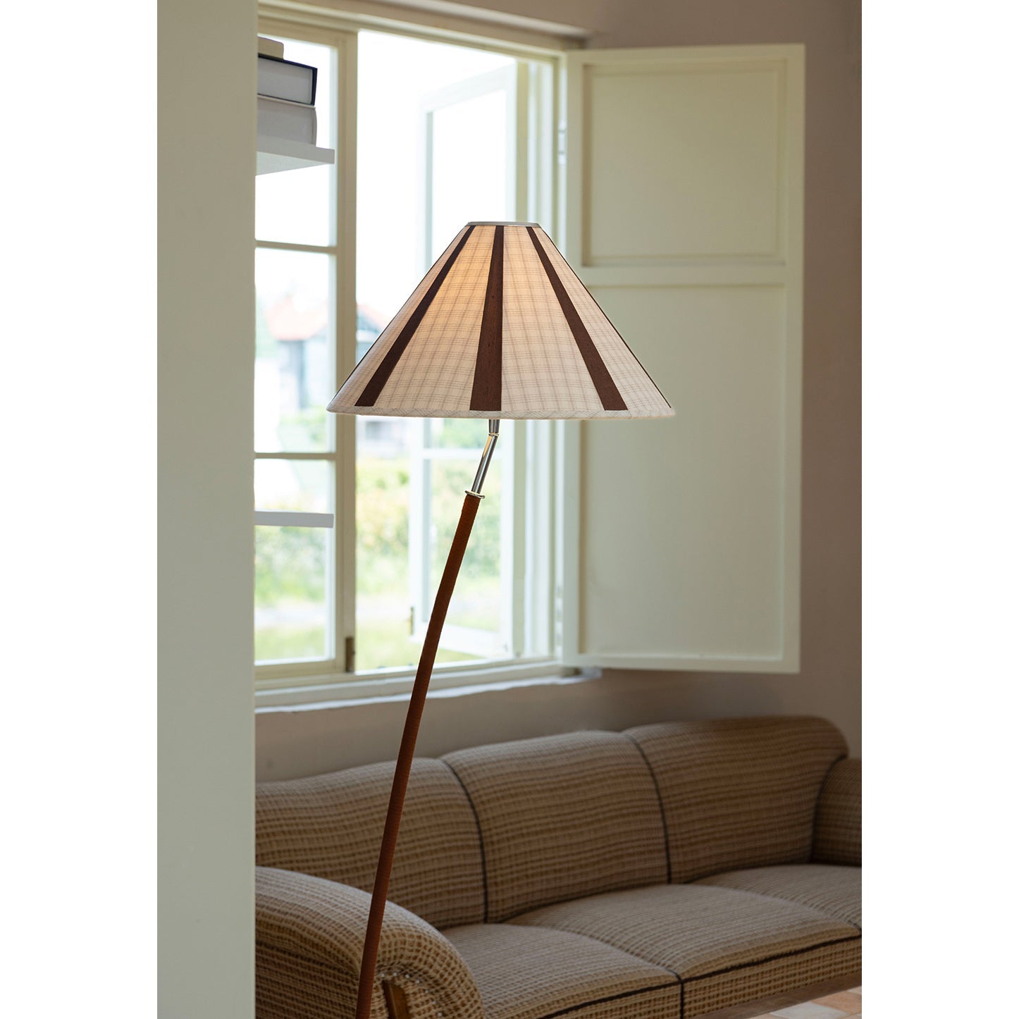 The floor lamp shown with a person to provide a sense of scale.