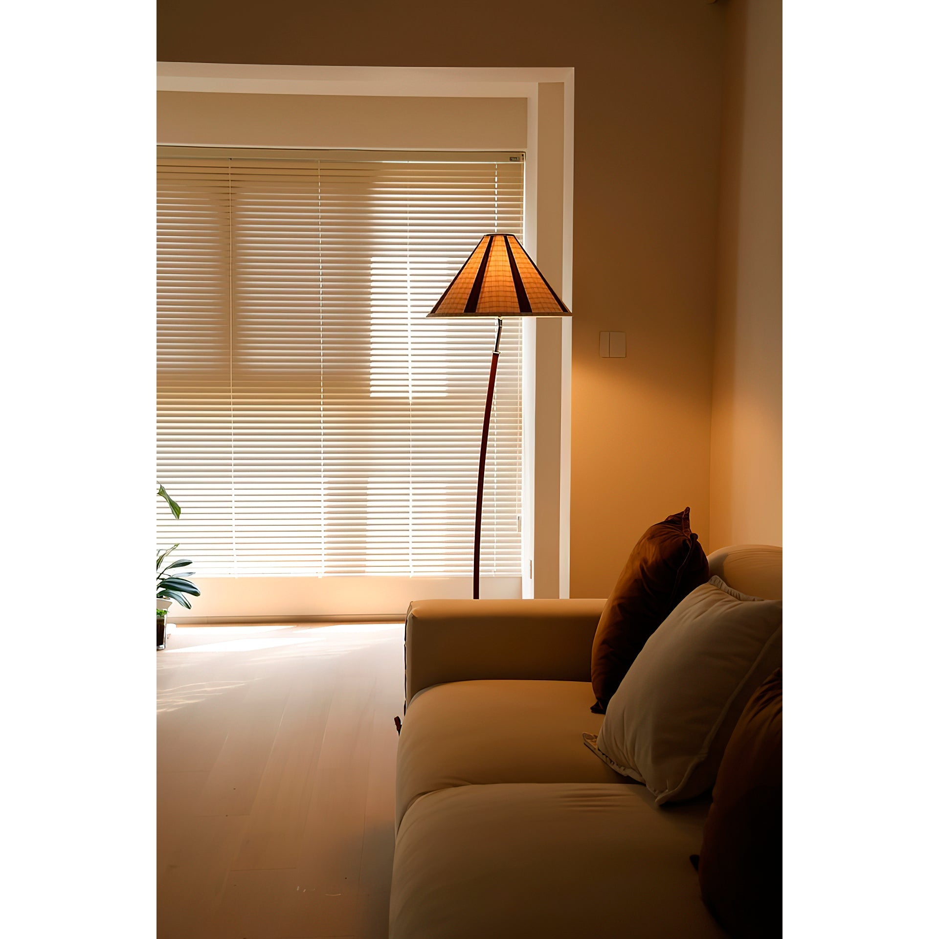 The sturdy metal base of the Dornstab Floor Lamp on a hardwood floor.