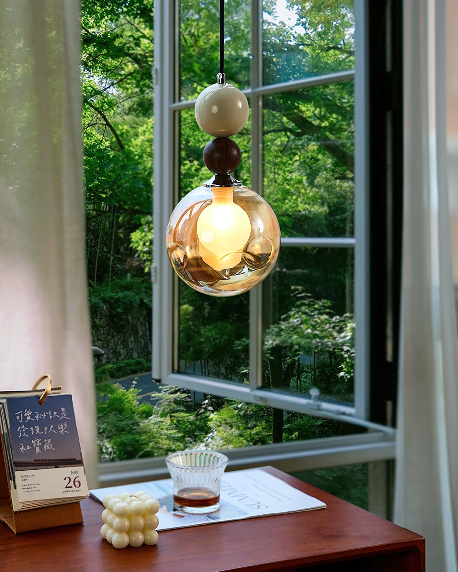 Dot Pendant Light shown illuminated, casting a warm glow.