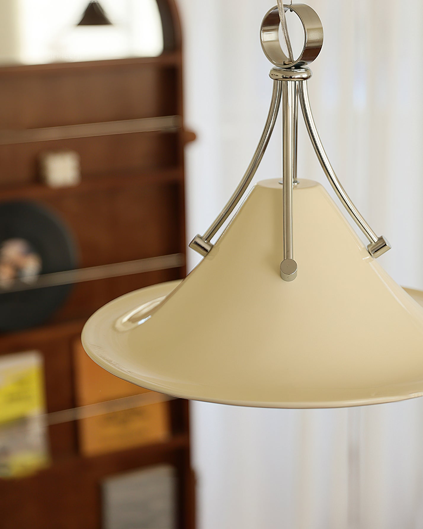 The Cream Dottie Pendant Light shown against a dark wall for contrast.