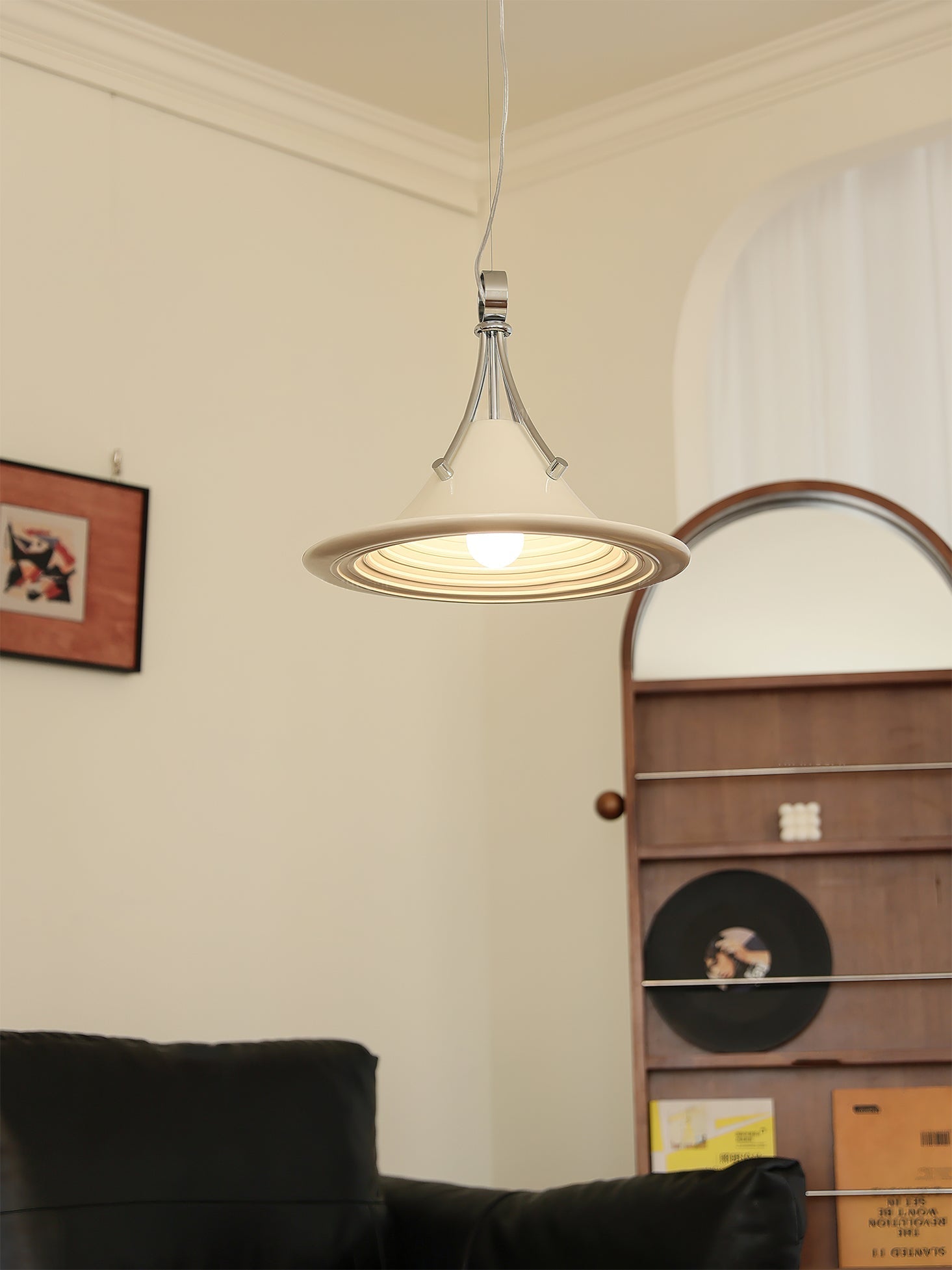 The Walnut Dottie Pendant Light in a cozy reading corner setting.